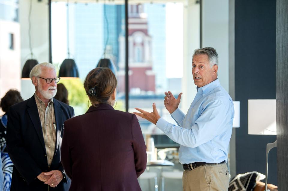 Developer Rick Dover, right, talks with guests at The Tribute - part hotel, part apartment, part short-term rental. This redevelopment of the former state supreme court site in downtown Knoxville is one half of Dover's plans for the property, which is preparing to welcome Church + Henley apartments next door, though the cost is not proportionate: $15 million for The Tribute and $63 million for Church + Henley.