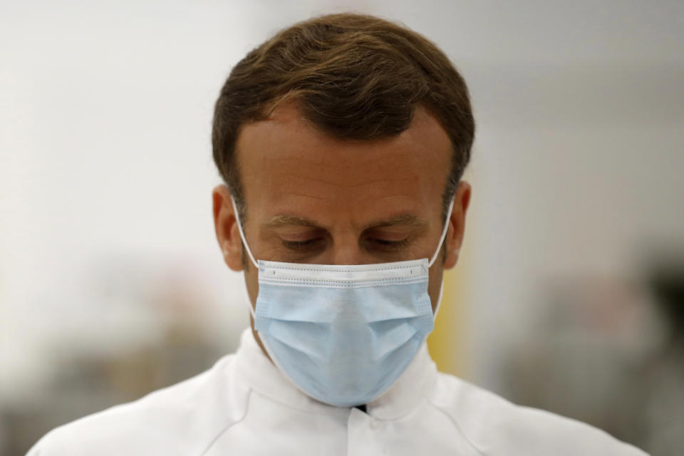 French President Emmanuel Macron looks down as he visits an industrial development laboratory at the French drugmaker's vaccine unit Sanofi Pasteur plant in Marcy-l'Etoile, near Lyon, central France, Tuesday, June 16, 2020. The visit comes after rival pharmaceutical company AstraZeneca this weekend announced a deal to supply 400 million vaccine doses to EU countries, including France. (Gonzalo Fuentes/Pool via AP)