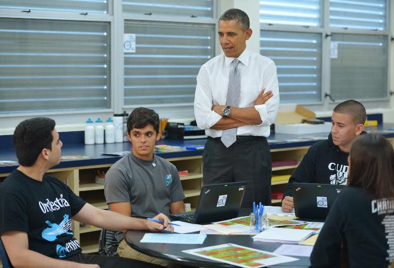 US President Barack Obama chats with students while visiting a classroom at Coral Reef High School in Miami, Florida on March 7, 2014