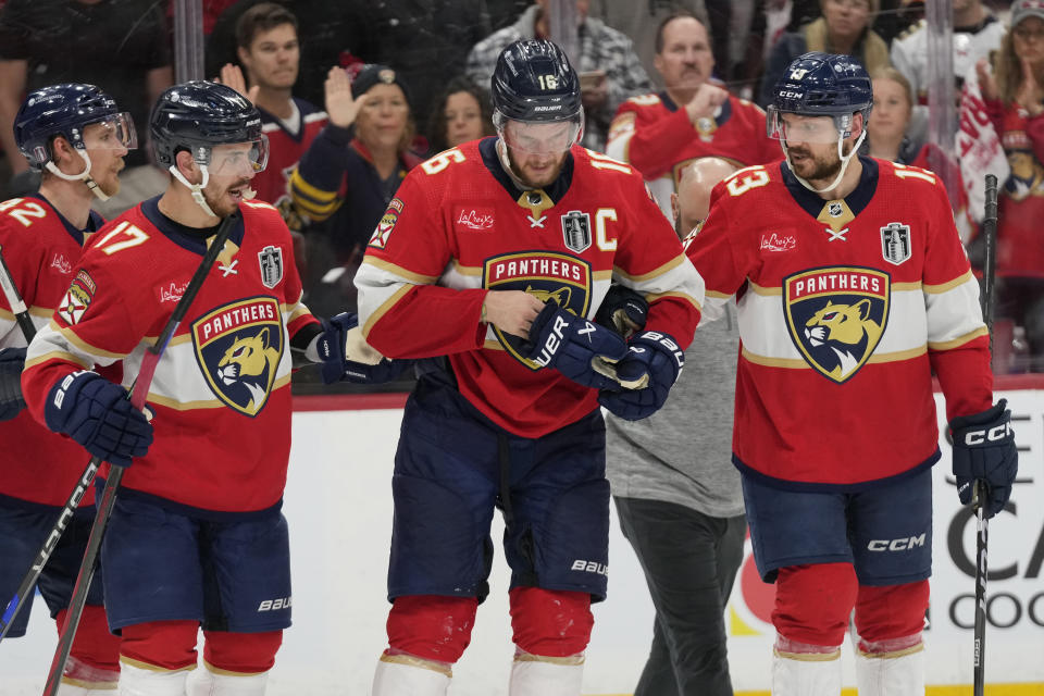 Florida Panthers center Aleksander Barkov (16) is assisted by teammates after he was injured during the third period of Game 2 of the NHL hockey Stanley Cup Finals against the Edmonton Oilers, Monday, June 10, 2024, in Sunrise, Fla. (AP Photo/Wilfredo Lee)