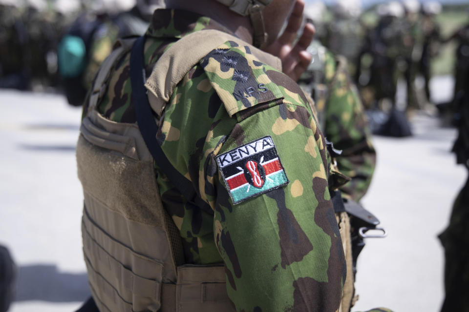 Police from Kenya stand at the Toussaint Louverture International Airport after landing in Port-au-Prince, Haiti, Tuesday, June 25, 2024. The first U.N.-backed contingent of foreign police arrived nearly two years after the Caribbean country requested help to quell a surge in gang violence. (AP Photo/Marckinson Pierre)