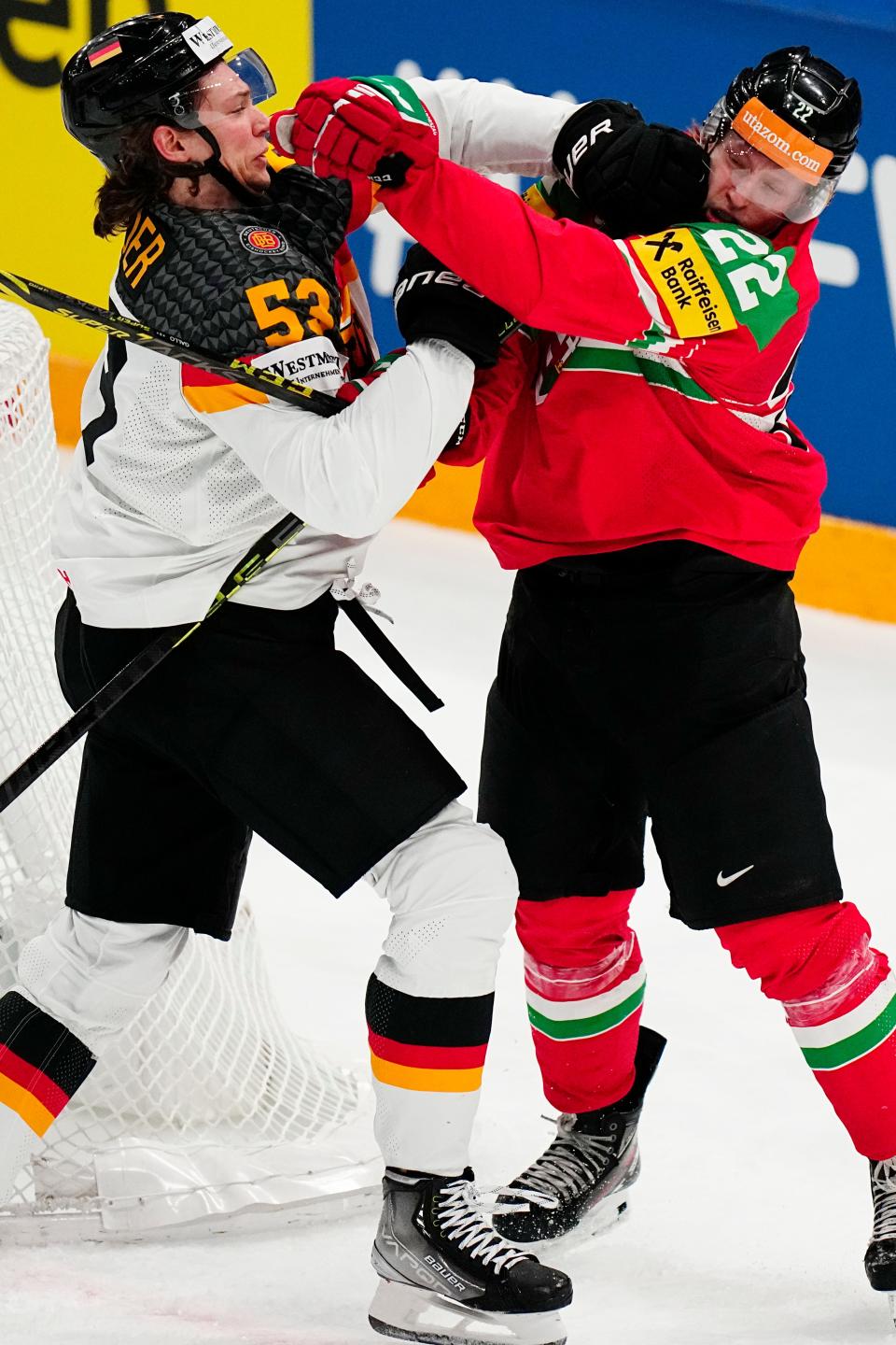 Germany's Moritz Seider, left, and Hungary's Vilmos Gallo fight at the ice hockey world championship in Tampere, Finland, Sunday, May 21, 2023.