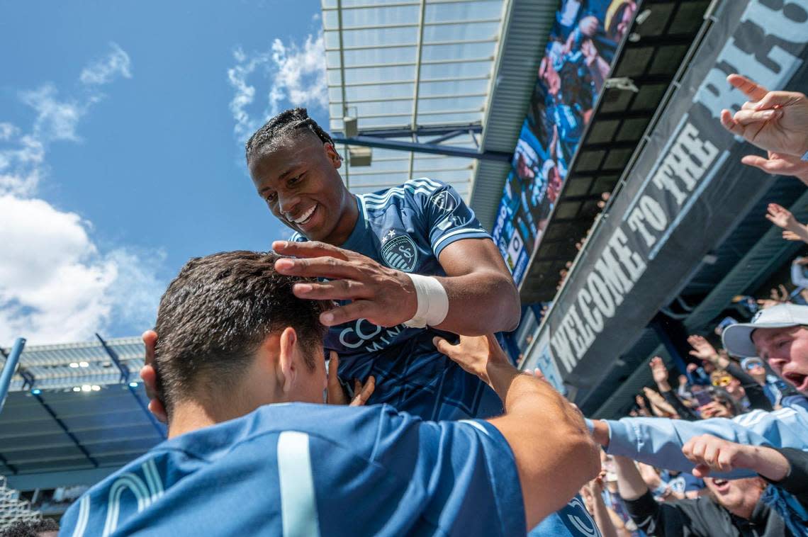 Sporting Kansas City defender Dany Rosero, top, celebrates with fans and teammates after scoring a goal against the Portland Timbers on Sunday at Children’s Mercy Park in Kansas City, Kan.