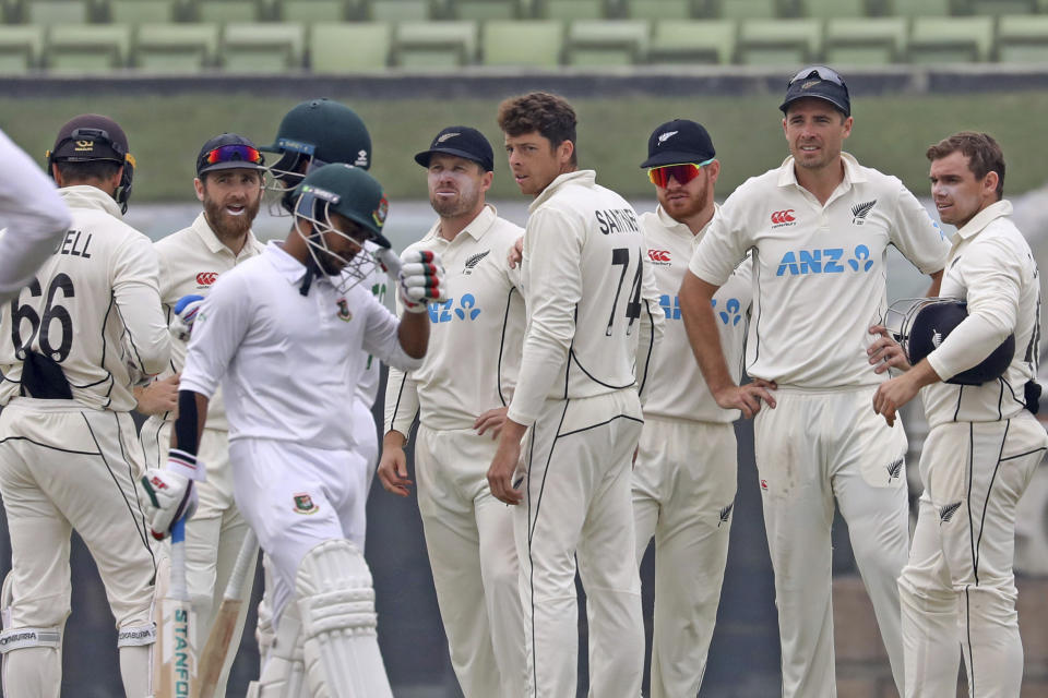 New Zealand Bowler Mitchell Santner, left, celebrates the wicket of Bangladesh's Mahmudul Hasan Joy during the fourth day of the second test cricket match between Bangladesh and New Zealand in Dhaka, Bangladesh, Saturday, Dec. 9, 2023. (AP Photo/Mosaraf Hossain)