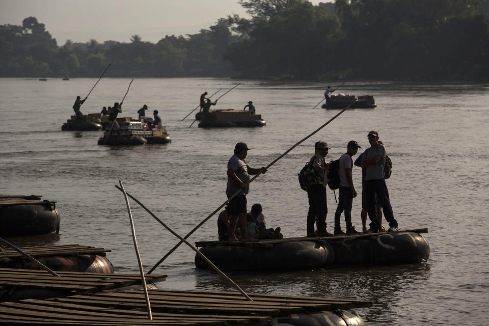 Rafts carry passengers and supplies across the Suchiate River between Tecun Uman, Guatemala, and Ciudad Hidalgo, Mexico, Friday, June 21, 2019. Mexico's foreign minister says that the country has completed its deployment of some 6,000 National Guard members to help control the flow of Central American migrants headed toward the U.S. (AP Photo/Oliver de Ros)