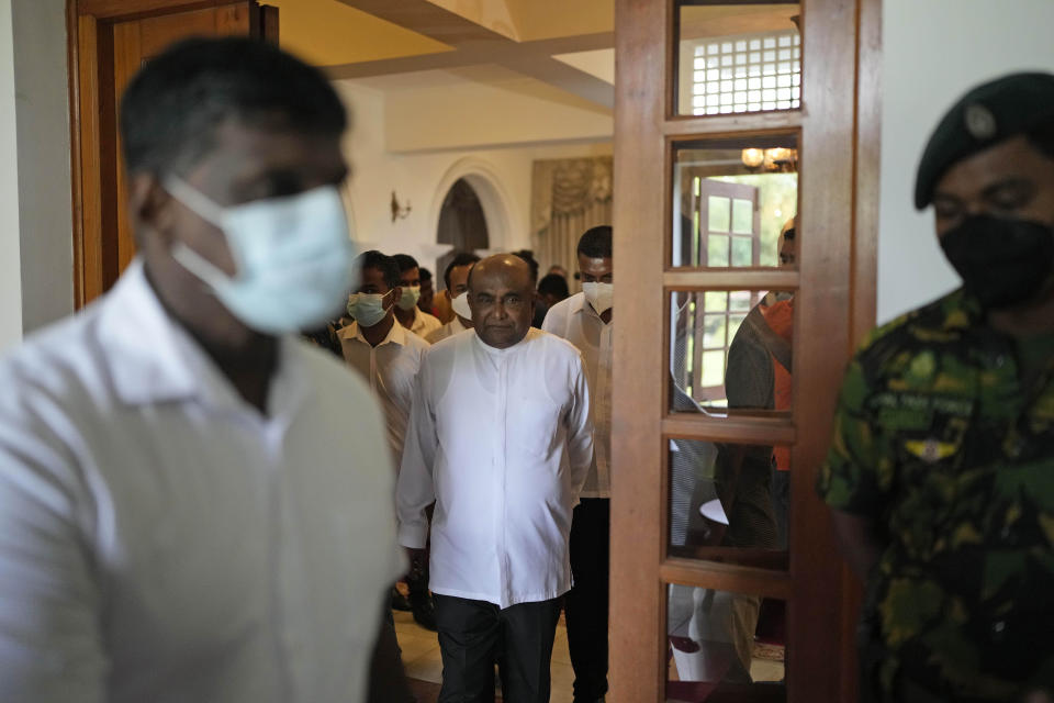 Sri Lanka's Parliament Speaker Mahinda Yapa Abeywardana leaves after addressing a press conference in Colombo, Sri Lanka, Friday, July 15, 2022. Abeywardana says President Gotabaya Rajapaksa has resigned and Parliament will convene to choose a new leader after massive protests took over government buildings to force him out of office. (AP Photo/Rafiq Maqbool)