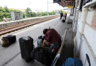 A traveler sleeps on the platform of the station of Saint Jean de Luz, southwestern France, Friday, Oct.18, 2019. A wildcat strike is disrupting train travel around France, as railway workers demand better security after a recent accident. (AP Photo/Bob Edme)