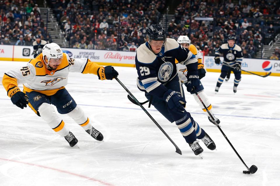 Dec 30, 2021; Columbus, Ohio, USA; Columbus Blue Jackets right wing Patrik Laine (29) carries the puck around Nashville Predators defenseman Alexandre Carrier (45) during the second period at Nationwide Arena. Mandatory Credit: Russell LaBounty-USA TODAY Sports