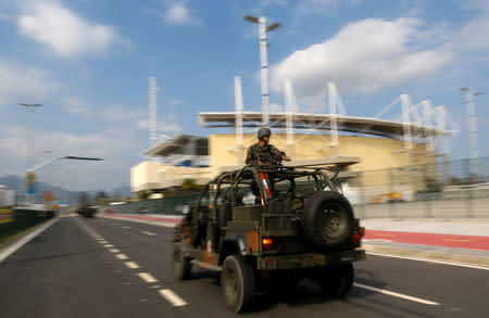 Brazilian Army soldiers patrol in front of the Olympic park ahead of the 2016 Rio Olympics in Rio de Janeiro, Brazil. REUTERS/Bruno Kelly