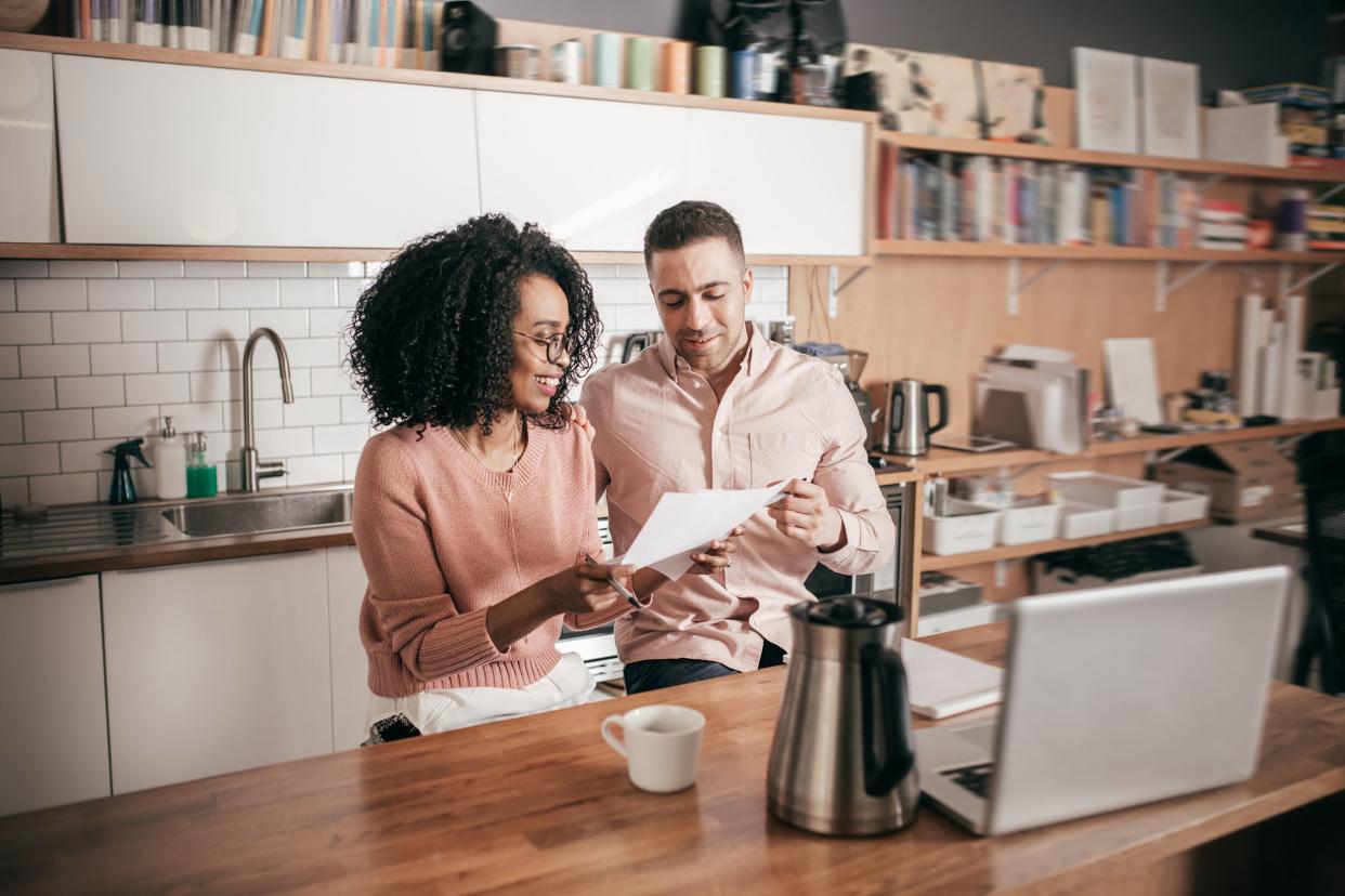 couple planning their finances on the kitchen