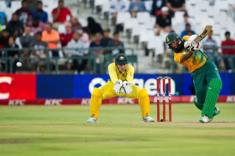 South African batsman Hashim Amla (R) plays a shot while Australian wicket keeper Peter Nevill keeps watch on March 9, 2016