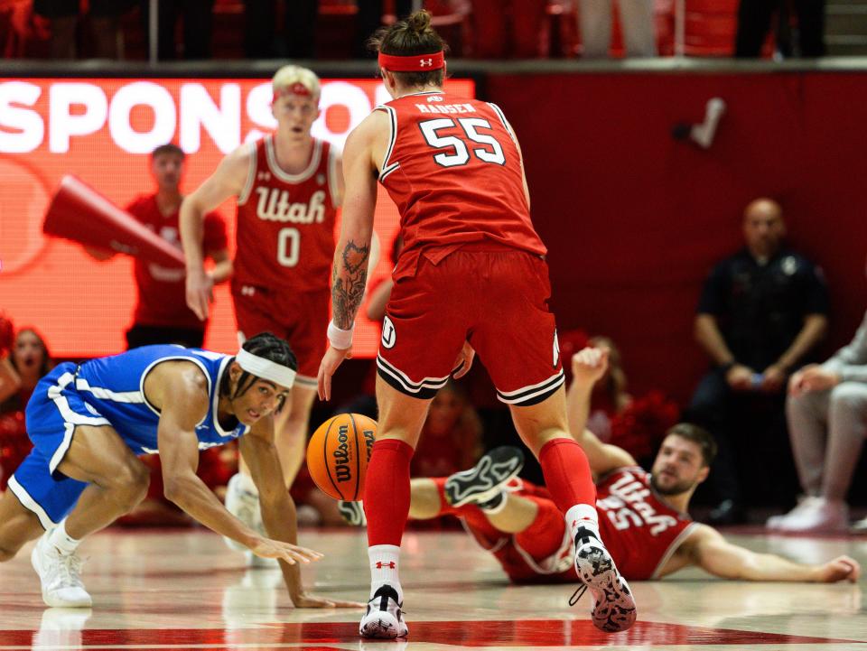 Left to right, Brigham Young Cougars guard Trey Stewart (1), Utah Utes guard Gabe Madsen (55), and Utah Utes guard Rollie Worster (25) scramble for the ball during a men’s basketball game at the Jon M. Huntsman Center in Salt Lake City on Saturday, Dec. 9, 2023. | Megan Nielsen, Deseret News