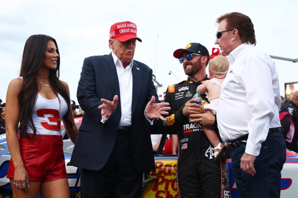 Former President Donald Trump talks with Austin Dillon, driver of the #3 Bass Pro Shops Chevrolet and team owner Richard Childress prior to the NASCAR Cup Series Coca-Cola 600 at Charlotte Motor Speedway on May 26.