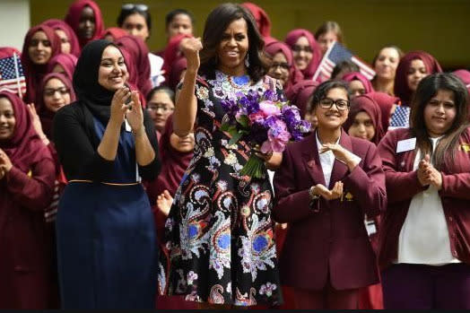 Michelle Obama wearing a paisley print dress to visit the Mulberry School for Girls.