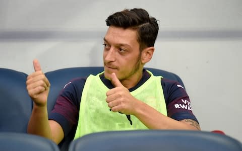 Ozil thumbs up from the sidelines - Credit: Reuters