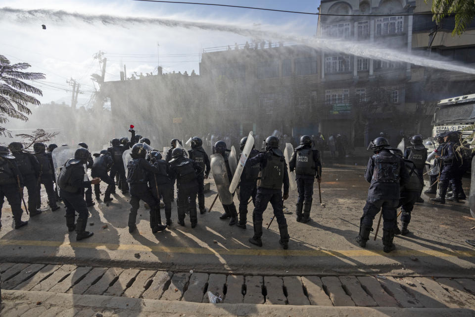 Nepalese police use water cannon to disperse protestors demanding a restoration of Nepal's monarchy in Kathmandu, Nepal, Thursday, Nov. 23, 2023. Riot police used batons and tear gas to halt tens of thousands of supporters of Nepal's former king demanding the restoration of the monarchy and the nation's former status as a Hindu state. Weeks of street protests in 2006 forced then King Gyanendra to abandon his authoritarian rule and introduce democracy. (AP Photo/Niranjan Shrestha)