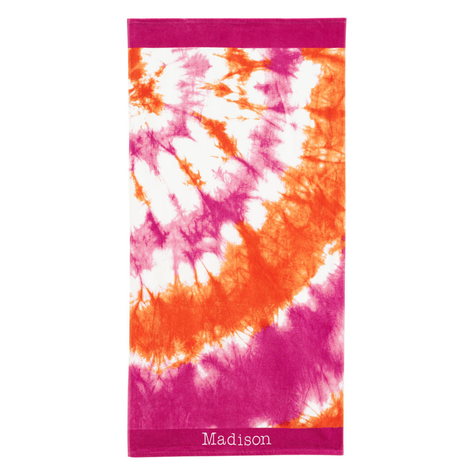 This product image released by Pottery Barn Teen shows a tie dye beach towel in pink and orange. Pottery Barn Teen has towels with surfer-cool designs like hibiscus flowers, Tiki prints and tie-dye patterns in summery hues, as well as sporty towels for baseball fans, with team logos. (AP Photo/Pottery Barn Teen)