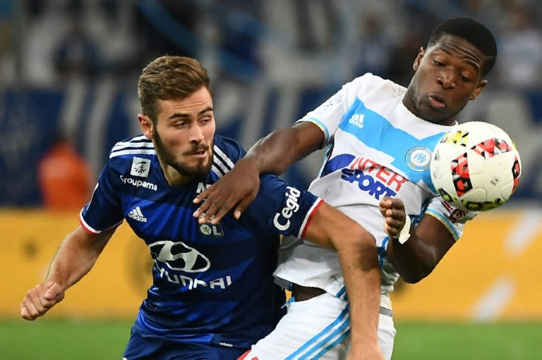 Olympique de Marseille's Belgian forward Aaron Leya Iseka (R) competes for the ball with Lyon's French midfielder Lucas Tousart during their French L1 football match Olympique of Marseille (OM) versus Lyon on September 18,2016