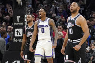 Sacramento Kings guard Malik Monk, center, celebrates as time runs out in double overtime while Los Angeles Clippers forward Norman Powell, left, and guard Eric Gordon look on during the second half of an NBA basketball game Friday, Feb. 24, 2023, in Los Angeles. The Kings won 176-175. (AP Photo/Mark J. Terrill)