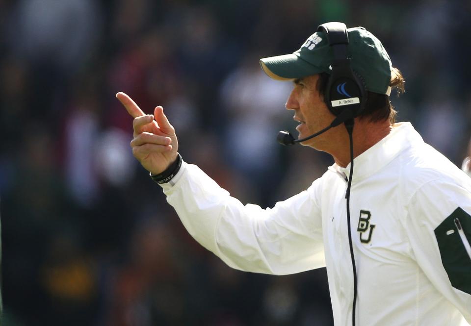 Former Baylor coach Art Briles is supported by his assistant coaches. (Getty)