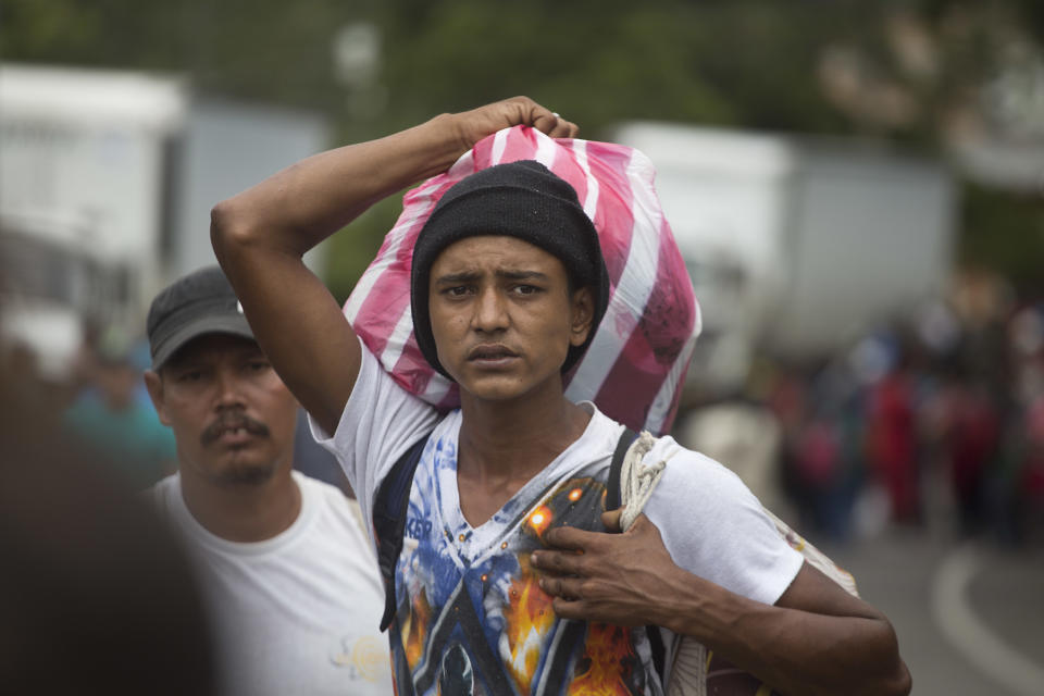 Hondurans march in a caravan of migrants moving toward the country's border with Guatemala in a desperate attempt to flee poverty and seek new lives in the United States, in Ocotepeque, Honduras, Monday, Oct. 15, 2018. The group has grown to an estimated 1,600 people from an initial 160 who first gathered early Friday in a northern Honduras city. They plan to try to enter Guatemala on Monday. (AP Photo/Moises Castillo)