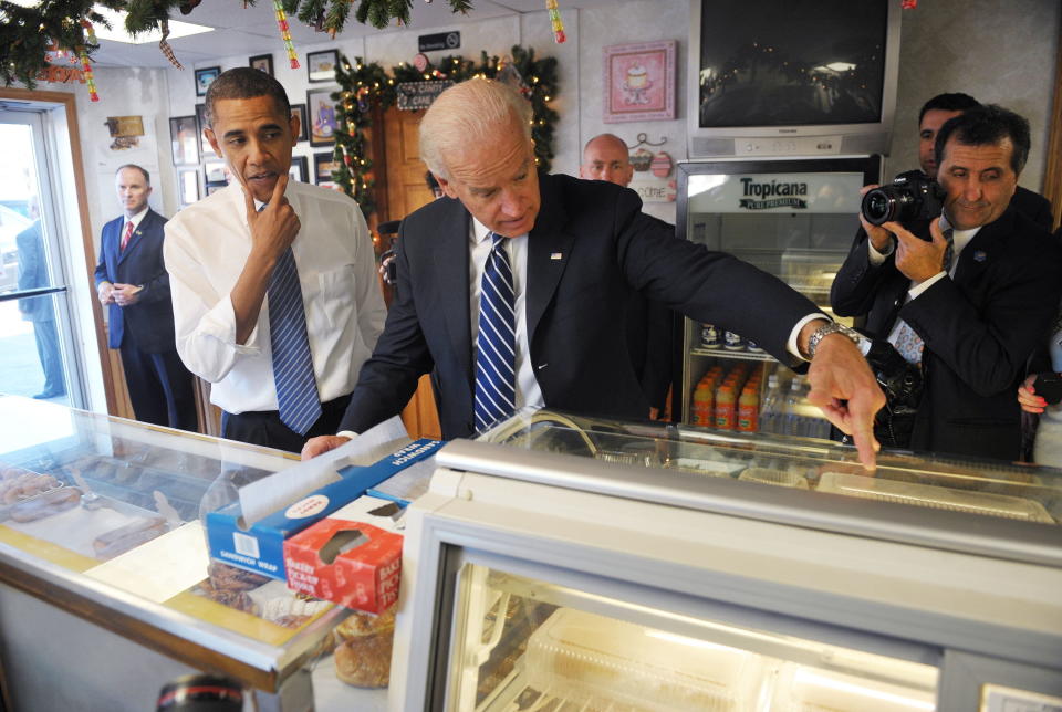 President Barack Obama (left) and Vice President Joe Biden select items from a display case during an unannounced visit to Gingerbread House Bakery November 23, 2010, in Kokomo, Indiana.