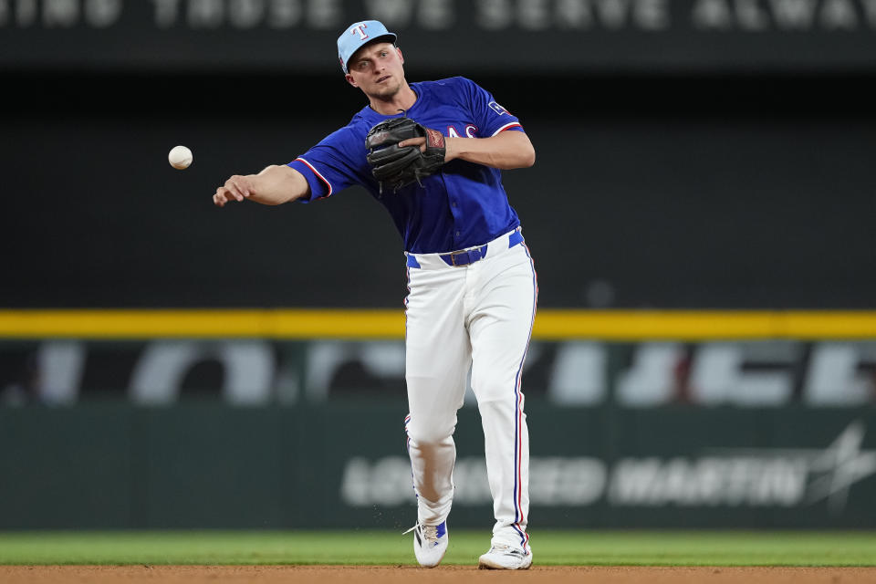 Texas Rangers shortstop Corey Seager throws to first after fielding a ground ball hit by Boston Red Sox Wilyer Abreu during the fourth inning of a spring training baseball game, Monday, March 25, 2024, in Arlington, Texas. (AP Photo/Sam Hodde)