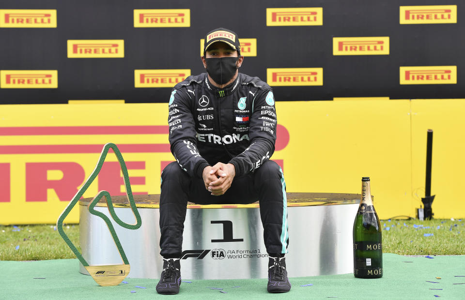 Mercedes driver Lewis Hamilton of Britain sits on the podium after winning the Styrian Formula One Grand Prix at the Red Bull Ring racetrack in Spielberg, Austria, Sunday, July 12, 2020. (Joe Klamar/Pool via AP)