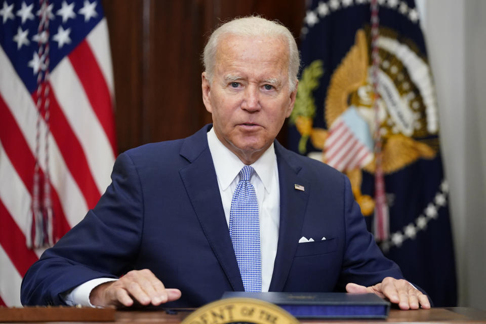 President Joe Biden prepares to stand after signing into law S. 2938, the Bipartisan Safer Communities Act gun safety bill in a ceremony in the Roosevelt Room of the White House in Washington, Saturday, June 25, 2022. (AP Photo/Pablo Martinez Monsivais)