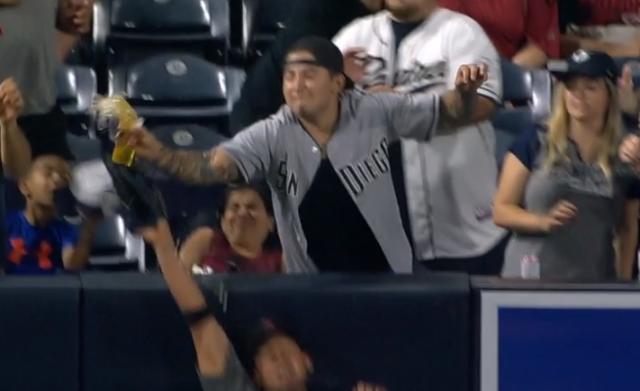 A Padres fan loses his beer but helps steal a home run for Eric Hosmer during Friday’s game at Petco Park. (MLB.TV)