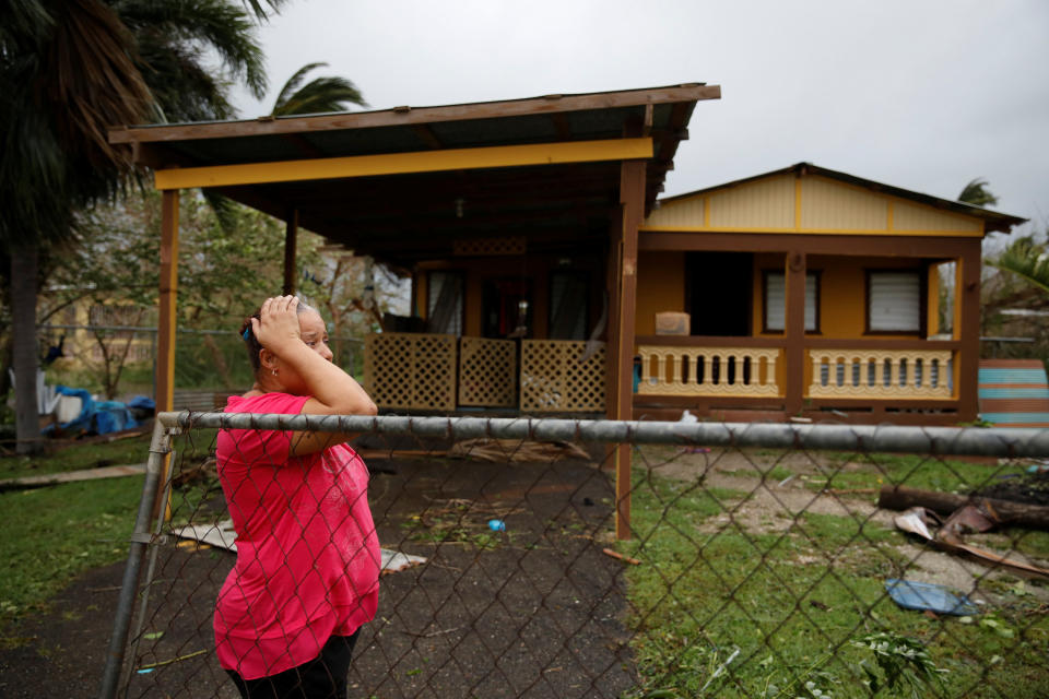 A woman reacts while looking at the damage to her house after the area was hit by Hurricane Maria in Guayama, Puerto Rico.&nbsp;