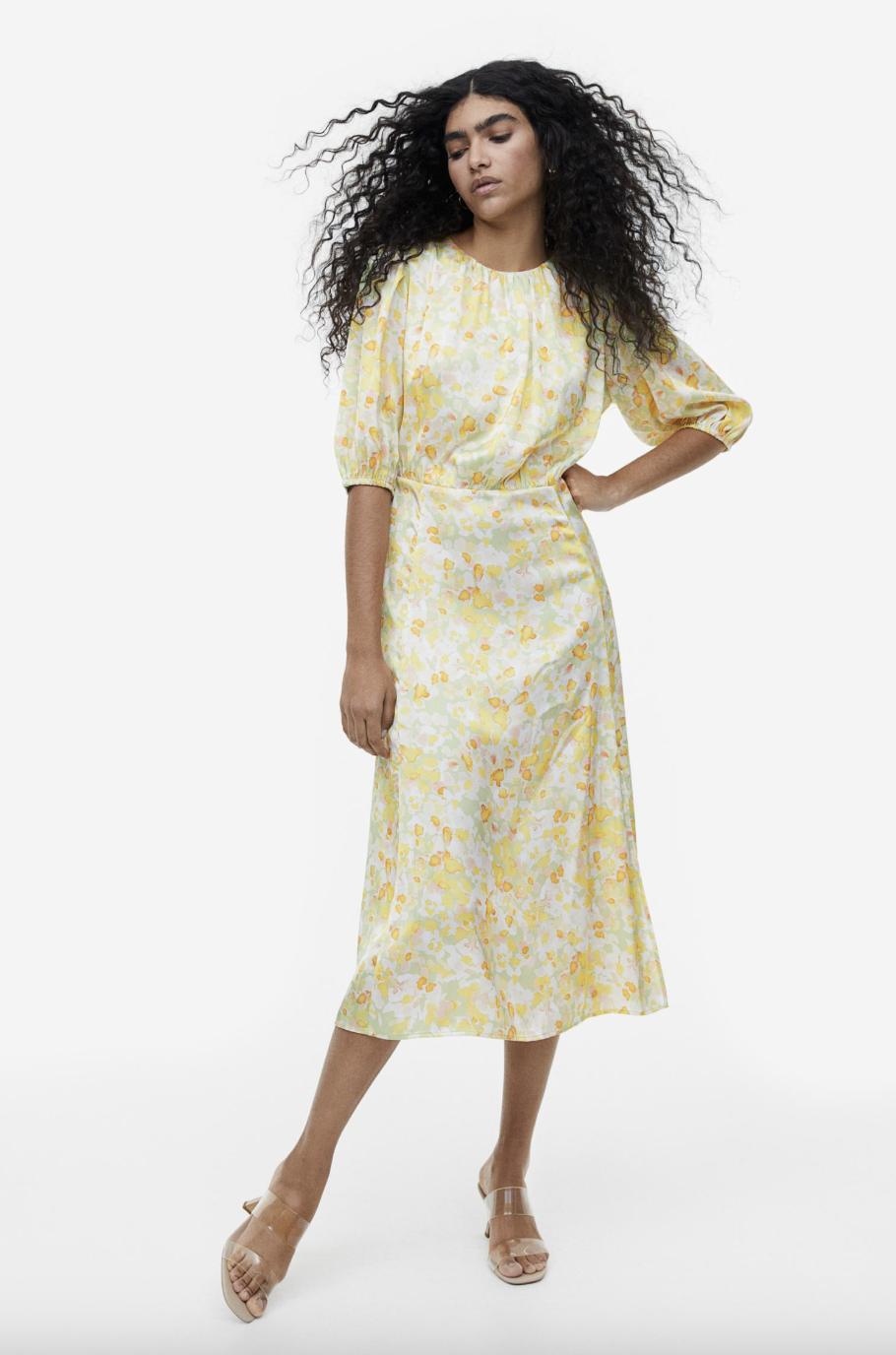 model with long black hair wearing pale yellow  floral Gathered Dress (photo via H&M)