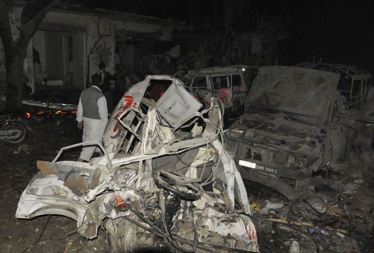 Destroyed vehicles remain at the site of a bomb attack in Quetta on January 10, 2013. Bomb attacks killed 92 people in Pakistan's city of Quetta on Thursday, as twin suicide bombers targeted a snooker hall frequented by Shiites in the deadliest single attack in the country for nearly two years