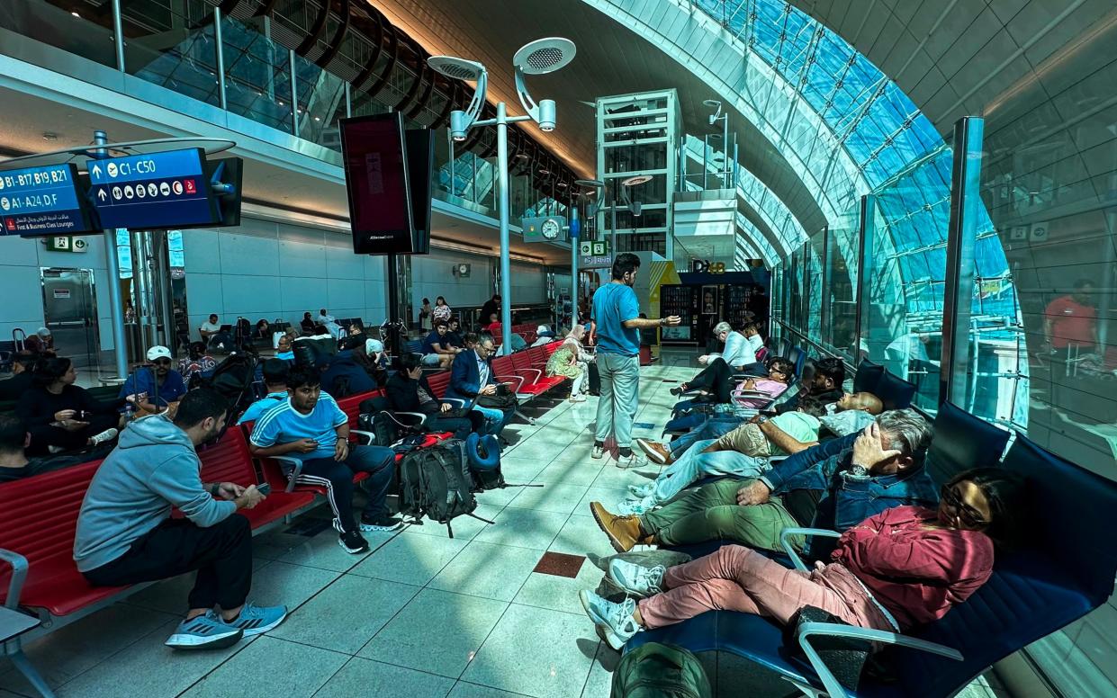 Passengers wait for their flights at the Dubai International Airport