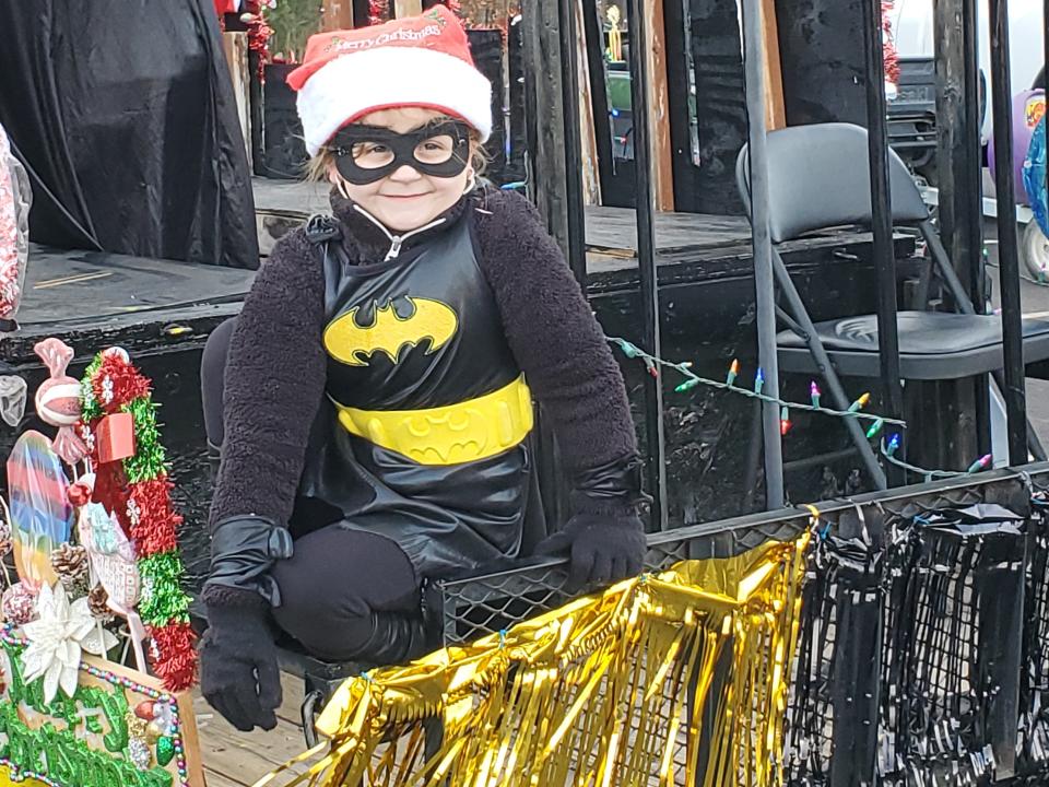 Delainy Robbins, 7, is Batgirl on the float "Christmas in Gotham" for Rochester's Holiday Parade Sunday, Dec. 5, 2021. The float was winner of both Best in Parade and Best in Community for the parade themed "A Comic Book Christmas."