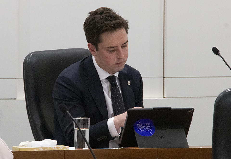 Michael Pettersson, the ACT Labor politician who proposed the legalization of marijuana for personal use and growing bills, looks at his computer Wednesday, Sept. 25, 2019, in parliament chamber in Canberra, Australia. Australia's capital has become the first part of the country to legalize recreational marijuana for personal use. (Jessica Brown/ABC News via AP)