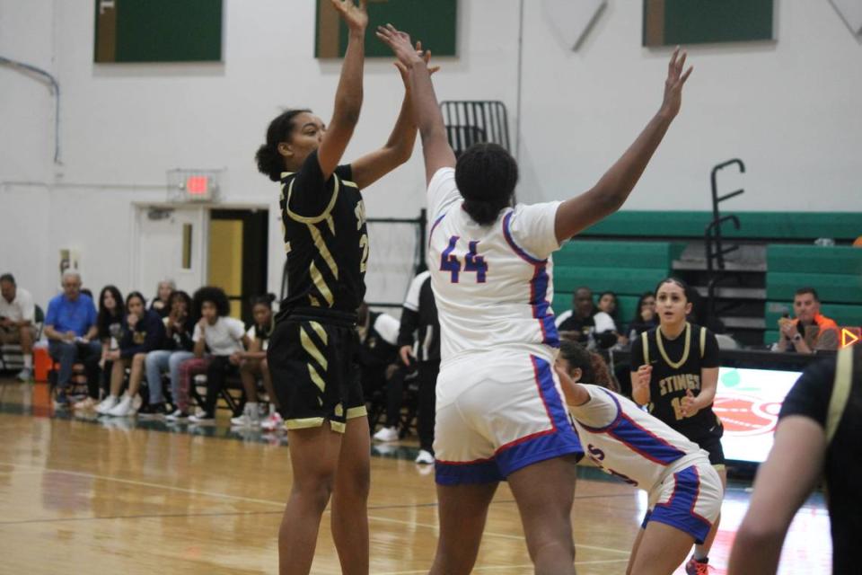 Miami High’s Joelle Wilson shoots a jumper over Peachtree Ridge’s center Aaliyah Hunt (44) during Friday night’s girls’ basketball final of the Junior Orange Bowl Classic at Westminster Christian.