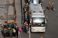 Workers leave a construction site at the end of their shift in the Central Business District in Beijing