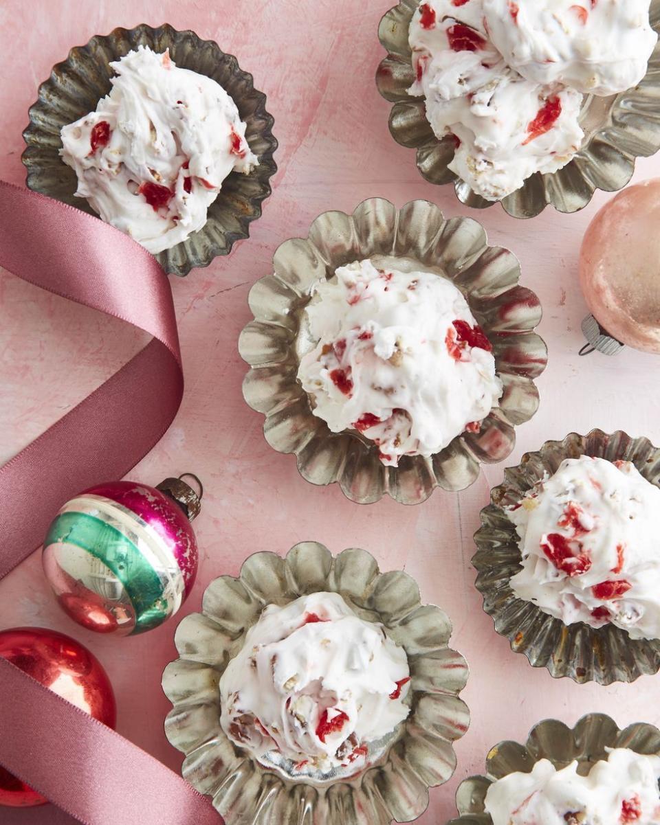 cherry and pecan divinity in tart tins with ornaments and ribbon around them