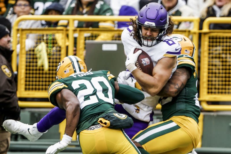 Minnesota Vikings tight end T.J. Hockenson (C) is tackled by Green Bay Packers defenders Sunday at Lambeau Field in Green Bay, Wis. Photo by Tannen Maury/UPI