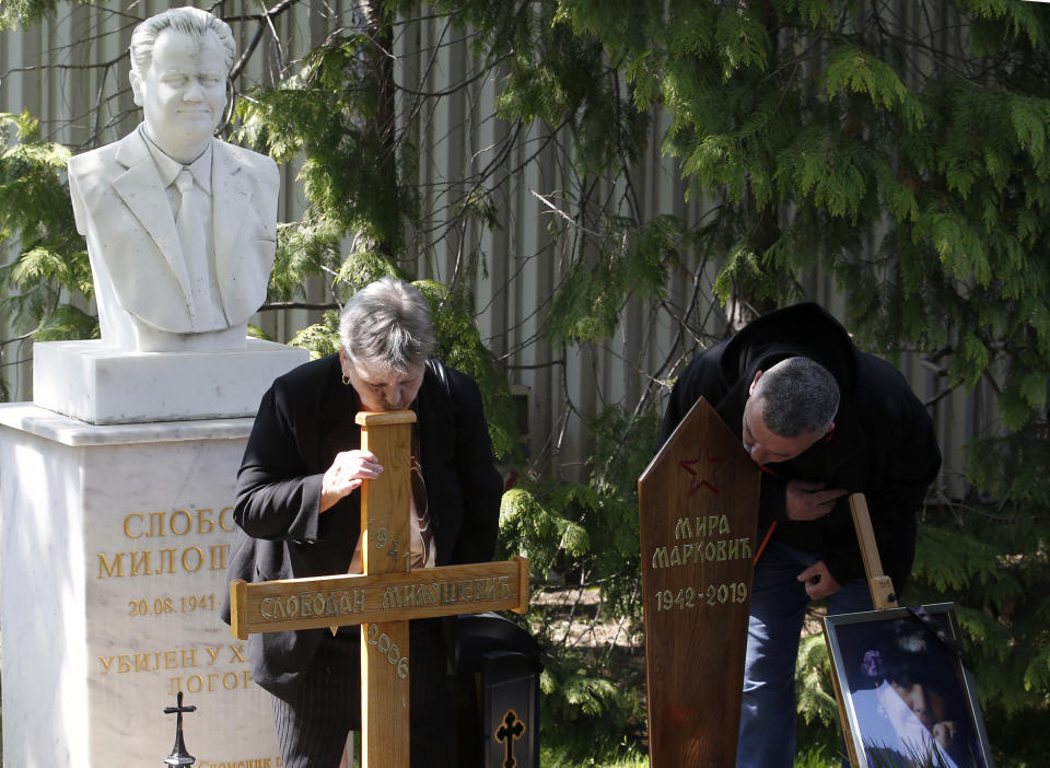 People pay last respect to Mirjana Markovic, the widow of former strongman Slobodan Milosevic during her funeral at the yard of his estate in his home town of Pozarevac, Serbia, Saturday, April 20, 2019. Markovic died last week in Russia where she had been granted asylum. The ex-Serbian first lady had fled there in 2003 after Milosevic was ousted from power in a popular revolt and handed over to the tribunal in The Hague, Netherlands. (AP Photo/Darko Vojinovic)