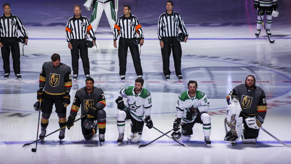 EDMONTON, ALBERTA - AUGUST 03:  Ryan Reaves #75 and Robin Lehner #90 of the Vegas Golden Knights kneel during the singing of the American national anthem alongside Jason Dickinson #18 and Tyler Seguin #91 of the Dallas Stars before the start of the Round Robin game during the 2020 NHL Stanley Cup Playoff at Rogers Place on August 03, 2020 in Edmonton, Alberta. (Photo by Dave Sandford/NHLI via Getty Images)