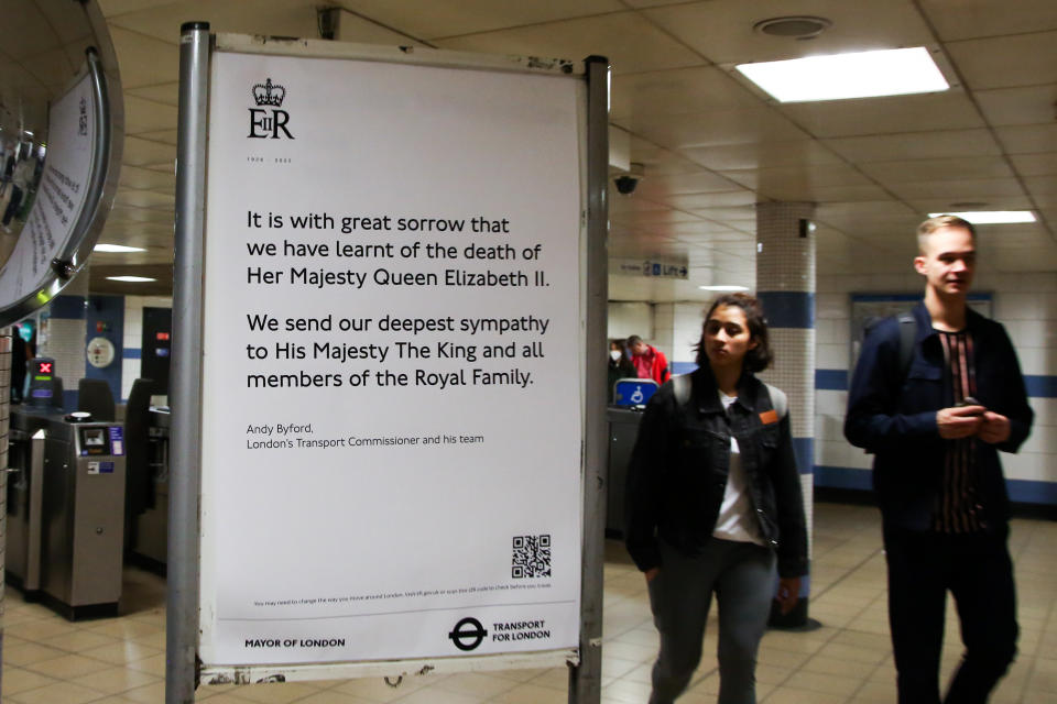 LONDON, UNITED KINGDOM - SEPTEMBER 09: Commuters walk past a message by Transport for London displayed at Green Park underground station following the announcement of the death of Queen Elizabeth II in London, United Kingdom on September 09, 2022. On September 08, The Queen, Britain's longest reigning monarch died at Balmoral Castle at the age of 96. (Photo by Dinendra Haria/Anadolu Agency via Getty Images)