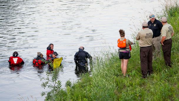 PHOTO: Water Recovery authorities comb the Apple River with metal detectors after five people were stabbed while tubing down the river in Somerset, Wis., July 30, 2022. (Alex Kormann/AP)