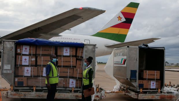 Workers offload Zimbabwe's first batch of COVID-19 vaccines from China on Feb. 15.