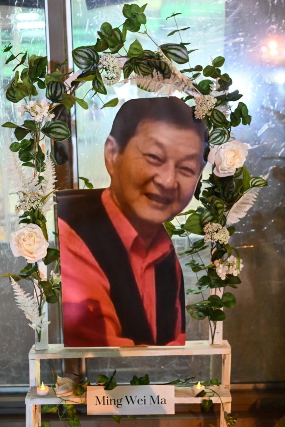 A portrait of Ming Wei Ma sits on display in front of the dance studio.