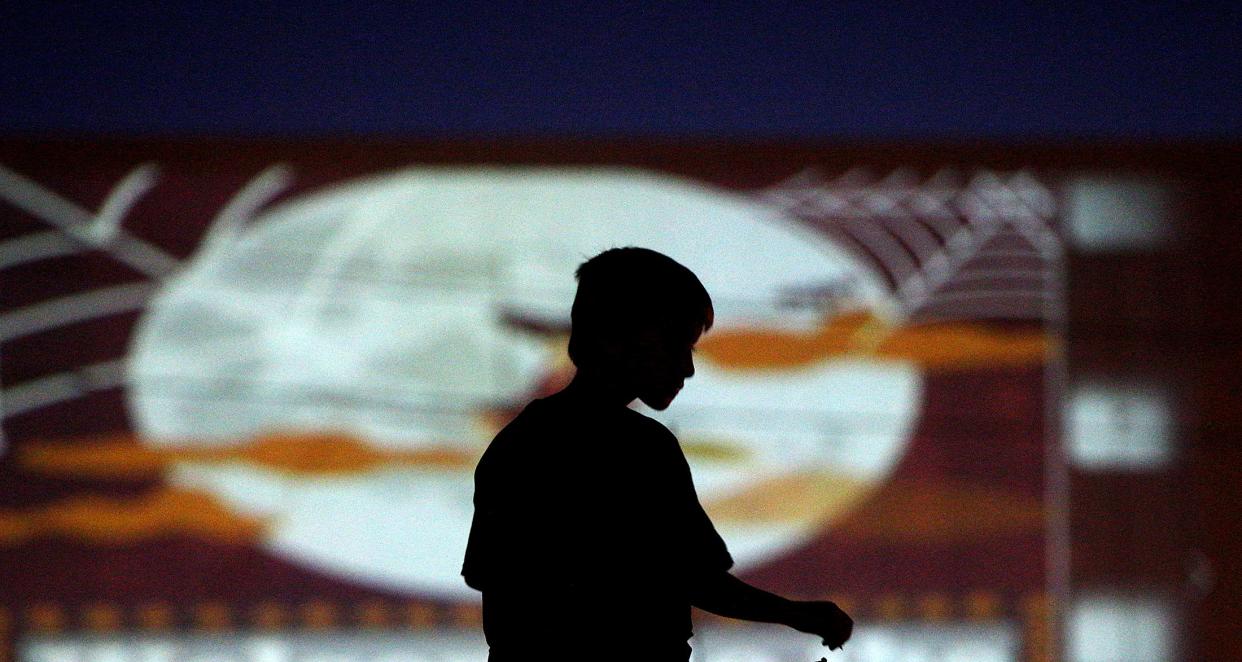 Sean Lara sits on top of a truck to get a better view of the drive in movie at the Angelo Civic Theatre on Saturday, Oct. 17, 2020.