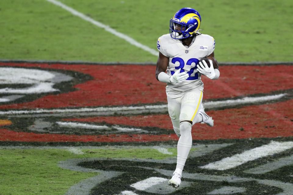 Rams safety Jordan Fuller runs with the ball after intercepting a pass by Buccaneers quarterback Tom Brady.