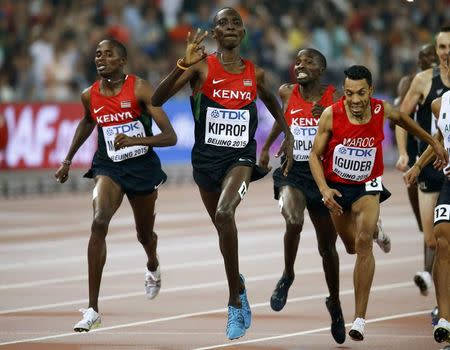 Kenya's Asbel Kiprop (C) celebrates as he crosses the finish line to win the men's 1500 metres final during the 15th IAAF World Championships at the National Stadium in Beijing, China August 30, 2015. REUTERS/Damir Sagolj