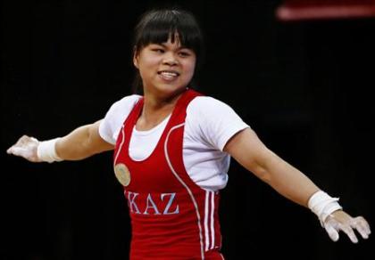 Kazakhstan's Zulfiya Chinshanlo reacts after setting new clean and jerk World record and total Olympic record on the women's 53Kg Group A weightlifting competition at the London 2012 Olympic Games July 29, 2012. (REUTERS/Kai Pfaffenbach)